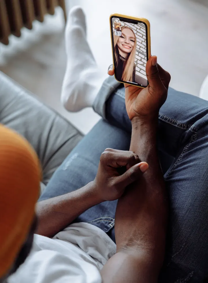 A man smiling on a video date